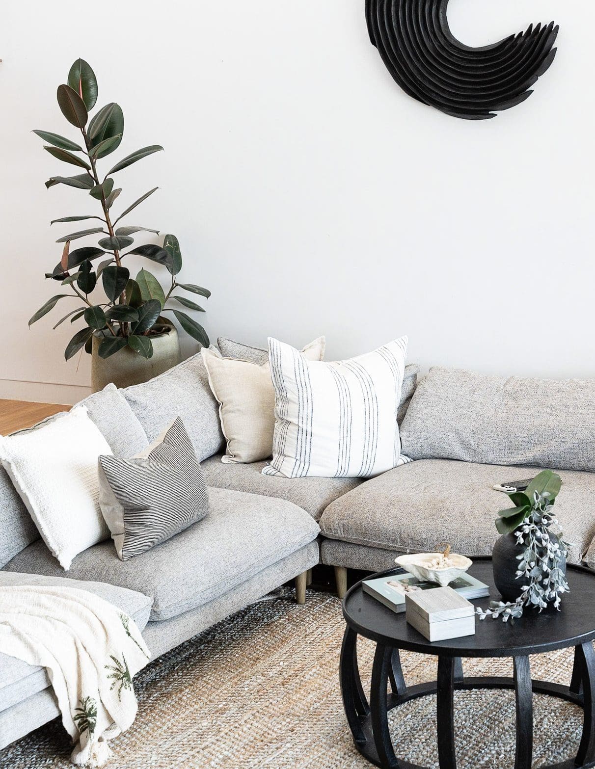staging-living-room-corner-plant-newcastle.jpg Corner of staged living room with sofa, plant and decor in Newcastle